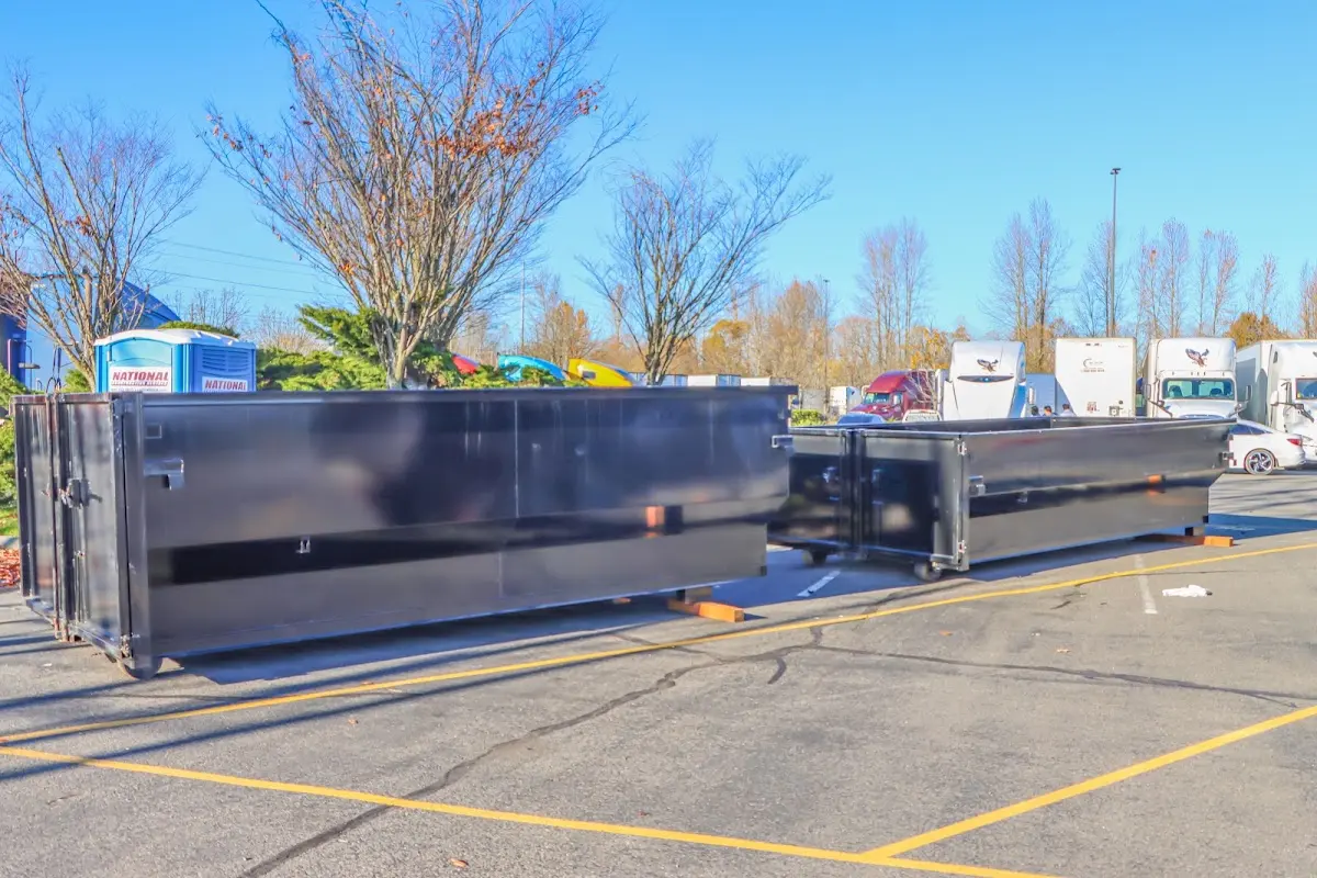 Professional dumpster rental service with roll-off container on residential driveway in Santa Fe Springs